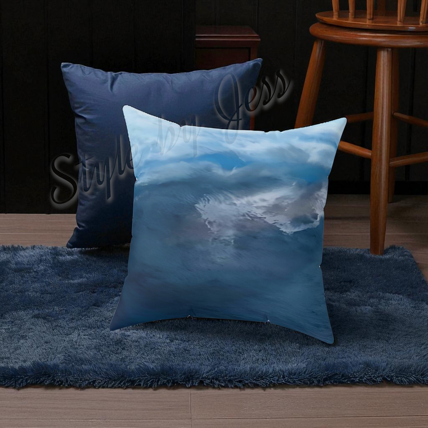 Decorative pillow with cloud design on a blue rug