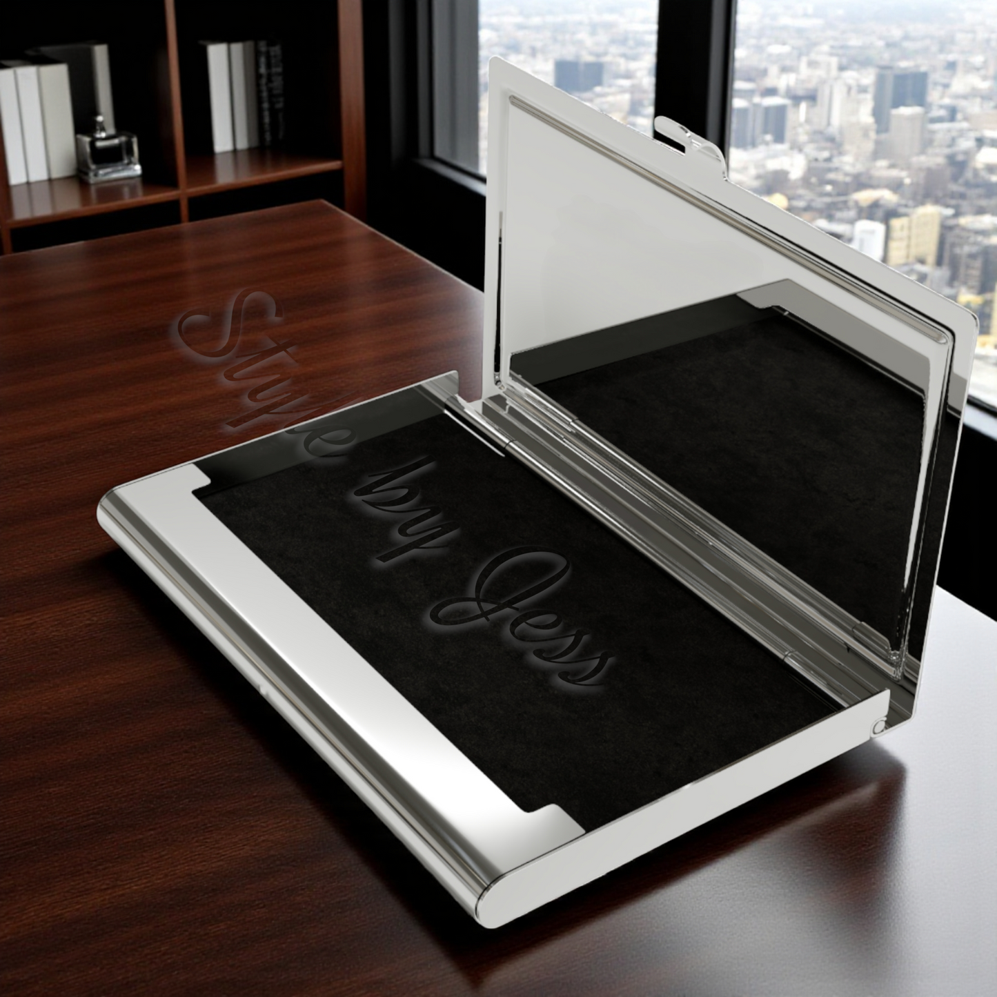 Silver metal business card holder open on a desk