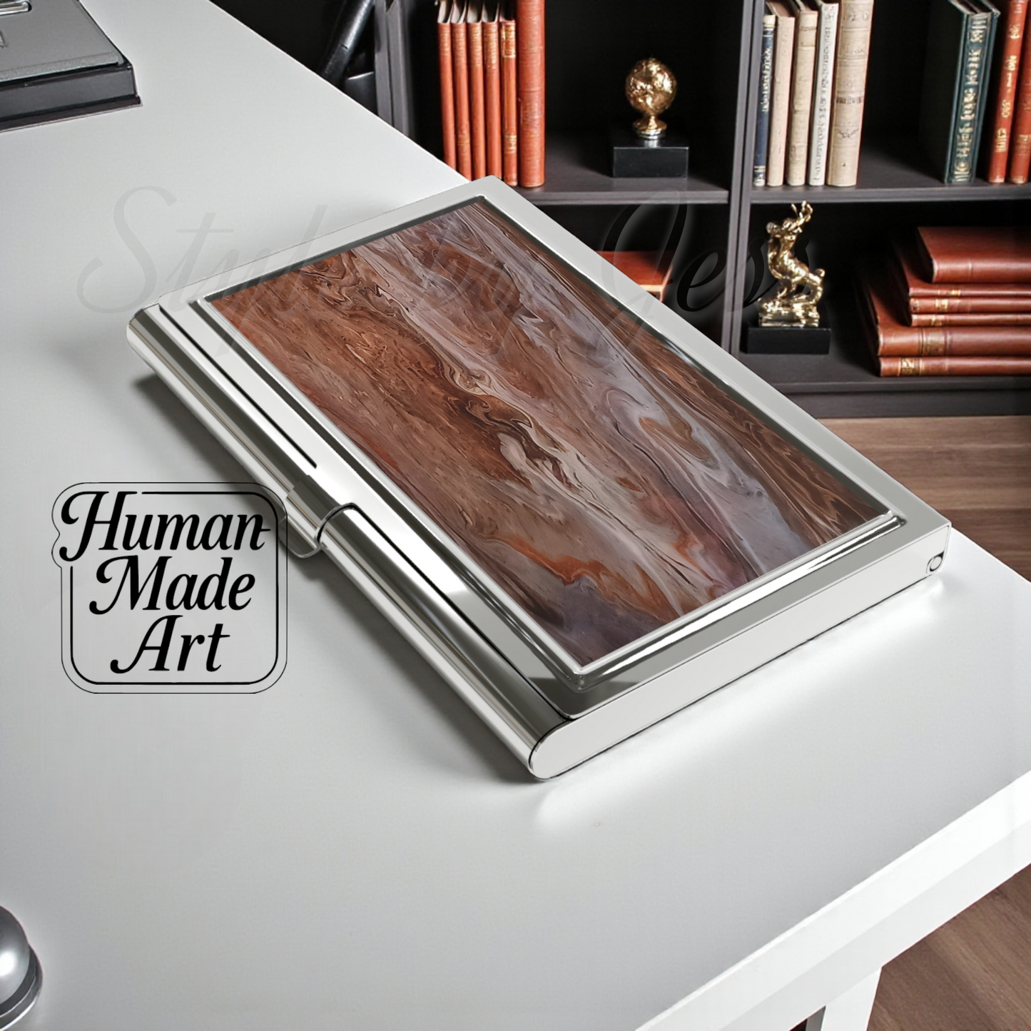 Wooden image on a business card holder on a desk with 'Human Made Art' branding.