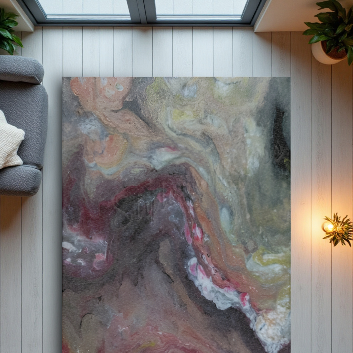 Abstract art on a front door rug in a room with a sofa and plants.