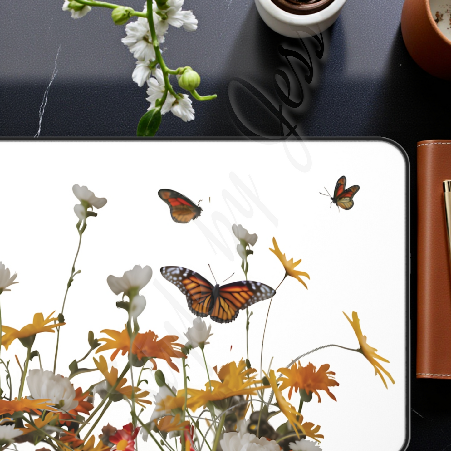 Tablet with butterfly and floral design on a desk with office supplies.