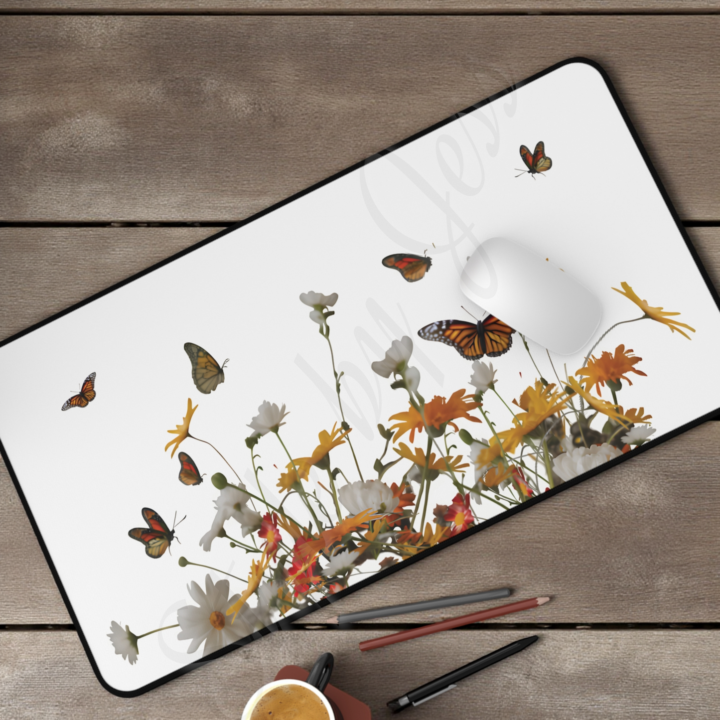 Floral and butterfly design on a desk mat with stationery items on a wooden surface