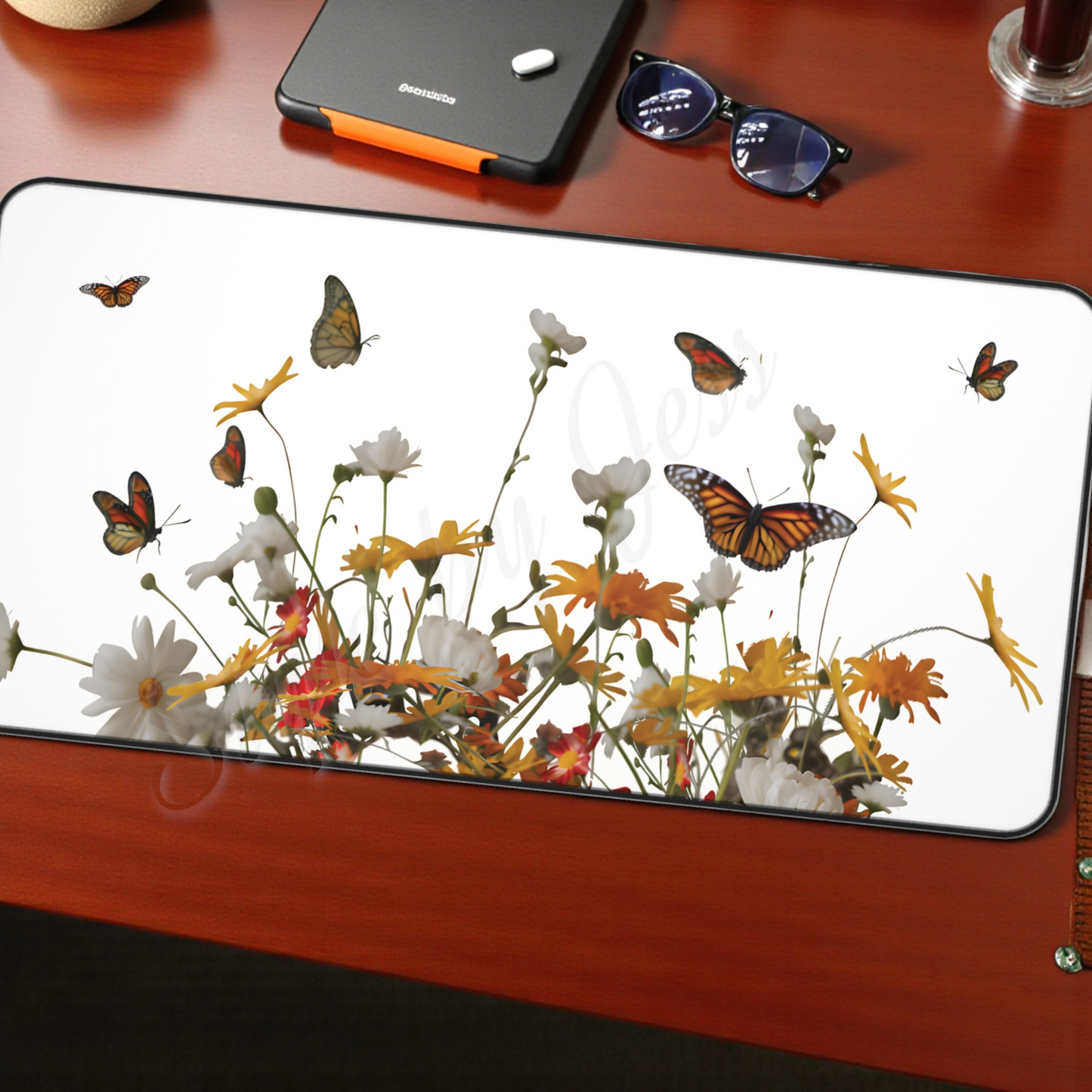 Large Mouse Pad with a floral and butterfly design mouse pad, sunglasses, and a smartphone.