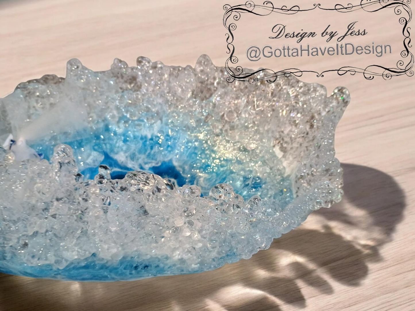 Crystal-like bowl with blue and clear design on a wooden surface, featuring 'Design by Jess' at the top.