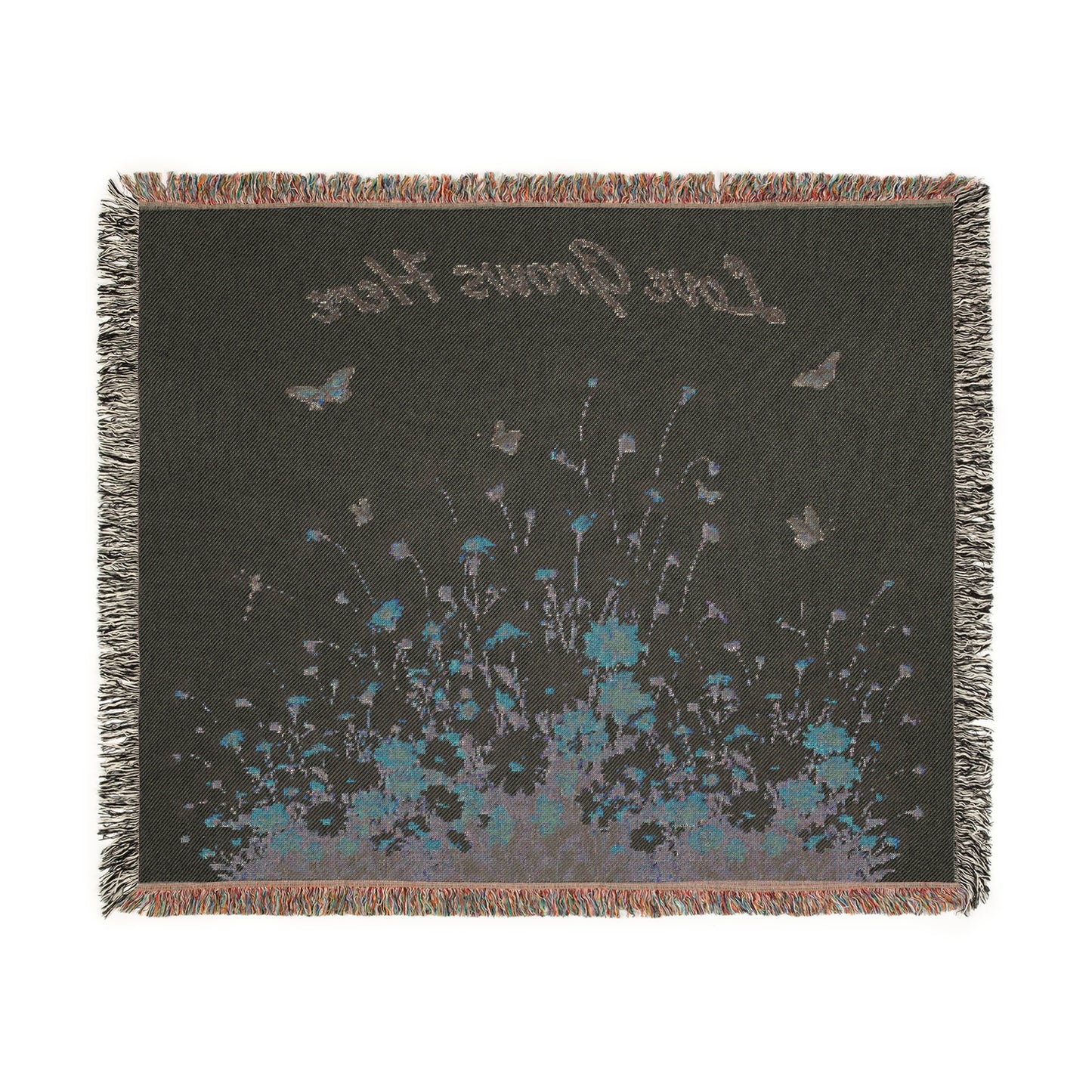 Decorative throw blanket with floral design and text on a plain background