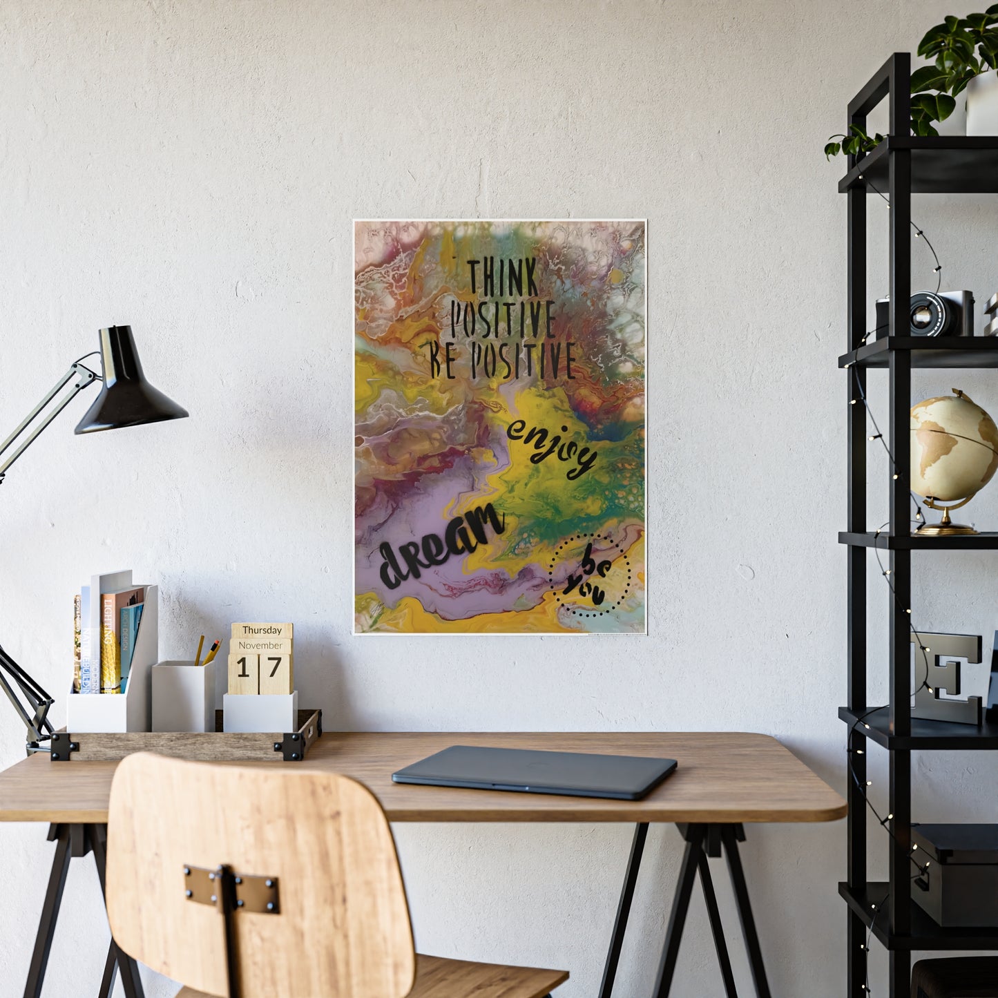 Decorative wall art with motivational quote in a home office setting