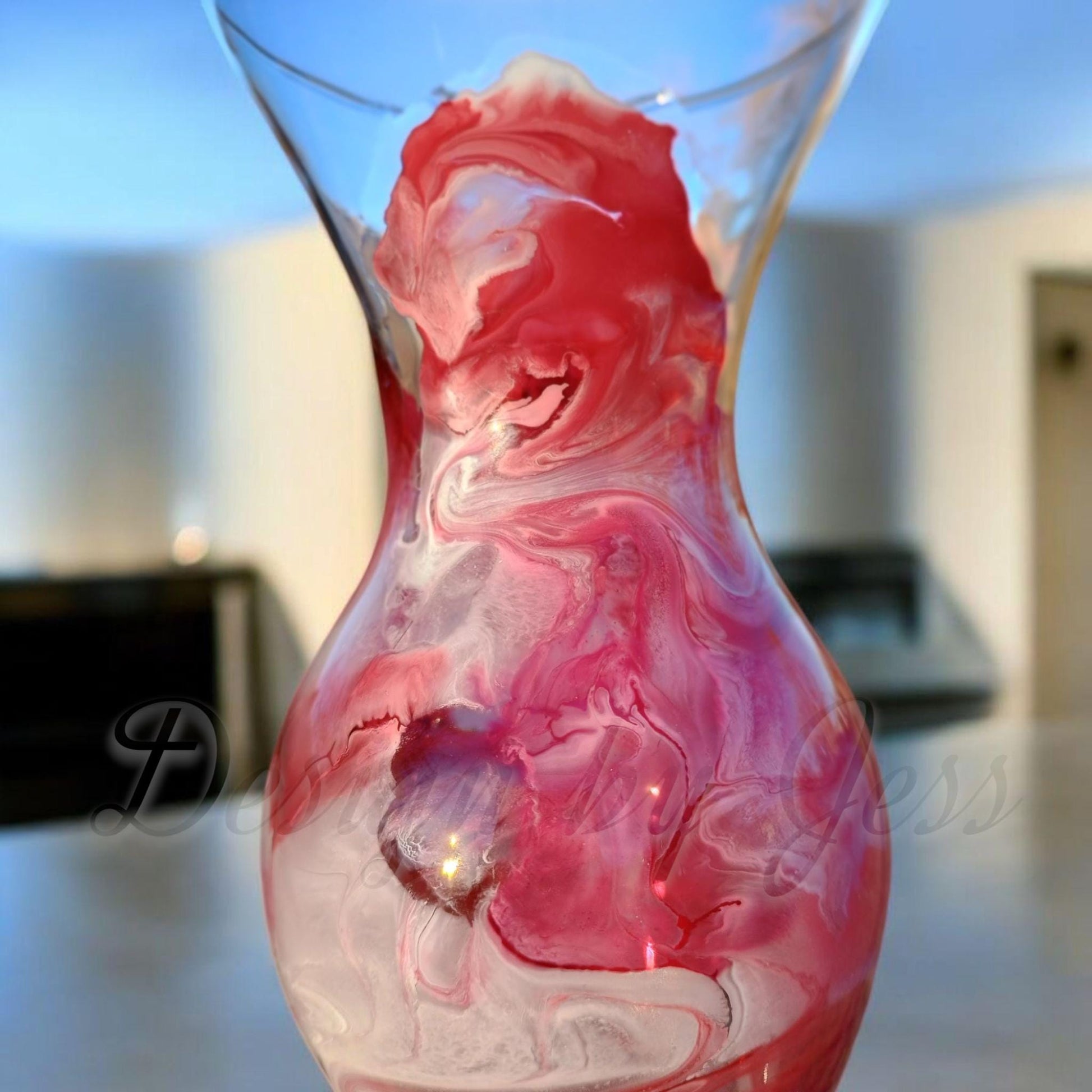 Glass vase with pink and white marbled design on a blurred background perfect home decor or living room accent. 
