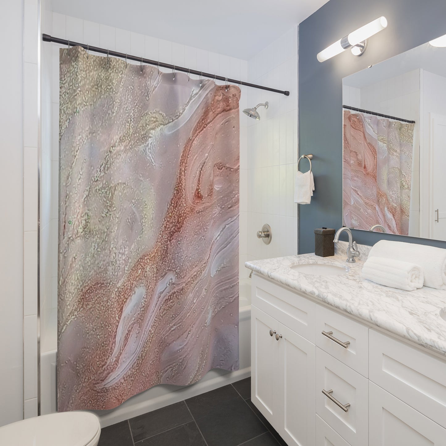 Bathroom with a marble-patterned shower curtain and white vanity in a modern style bathroom.