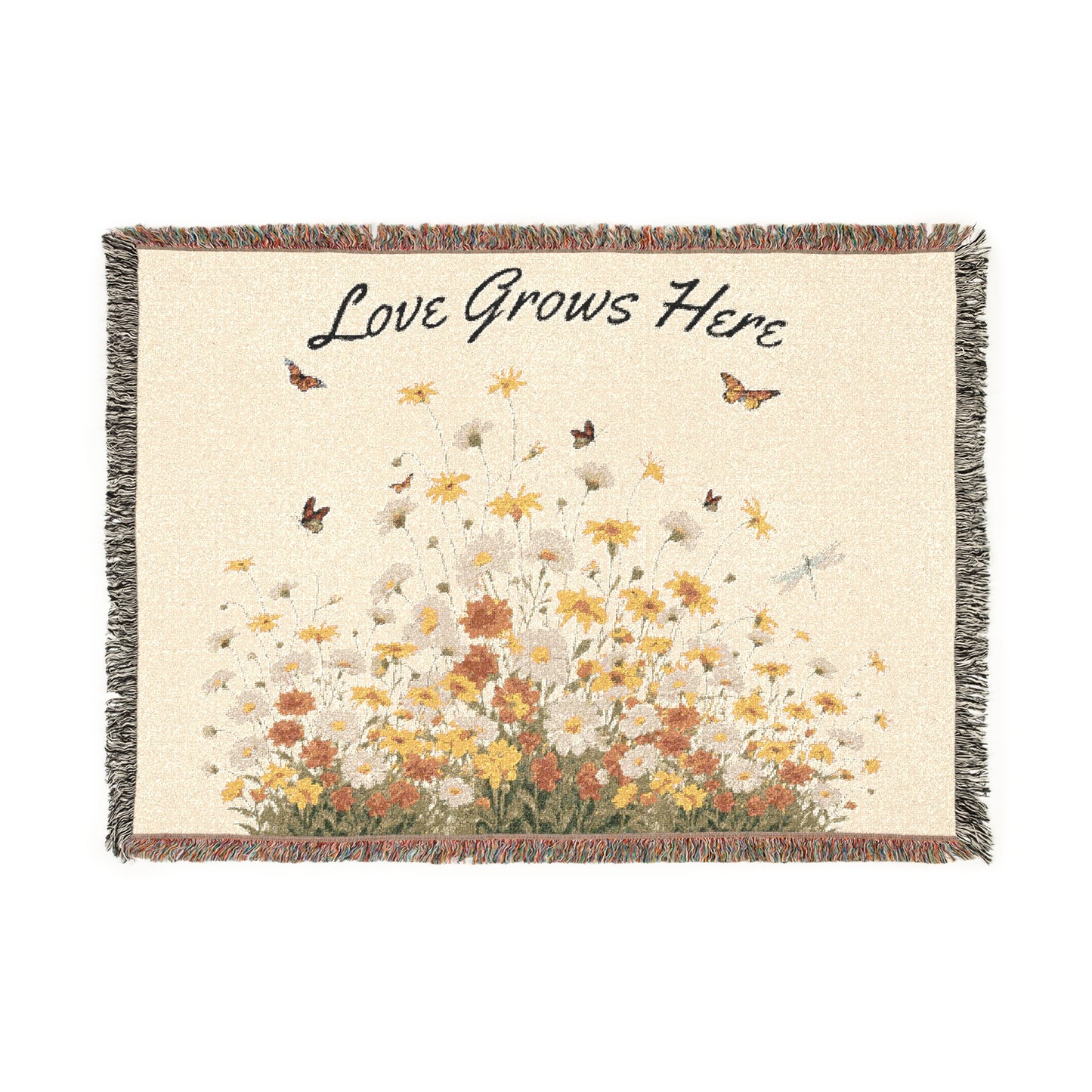 Blanket with floral design and 'Love Grows Here' text on a white background