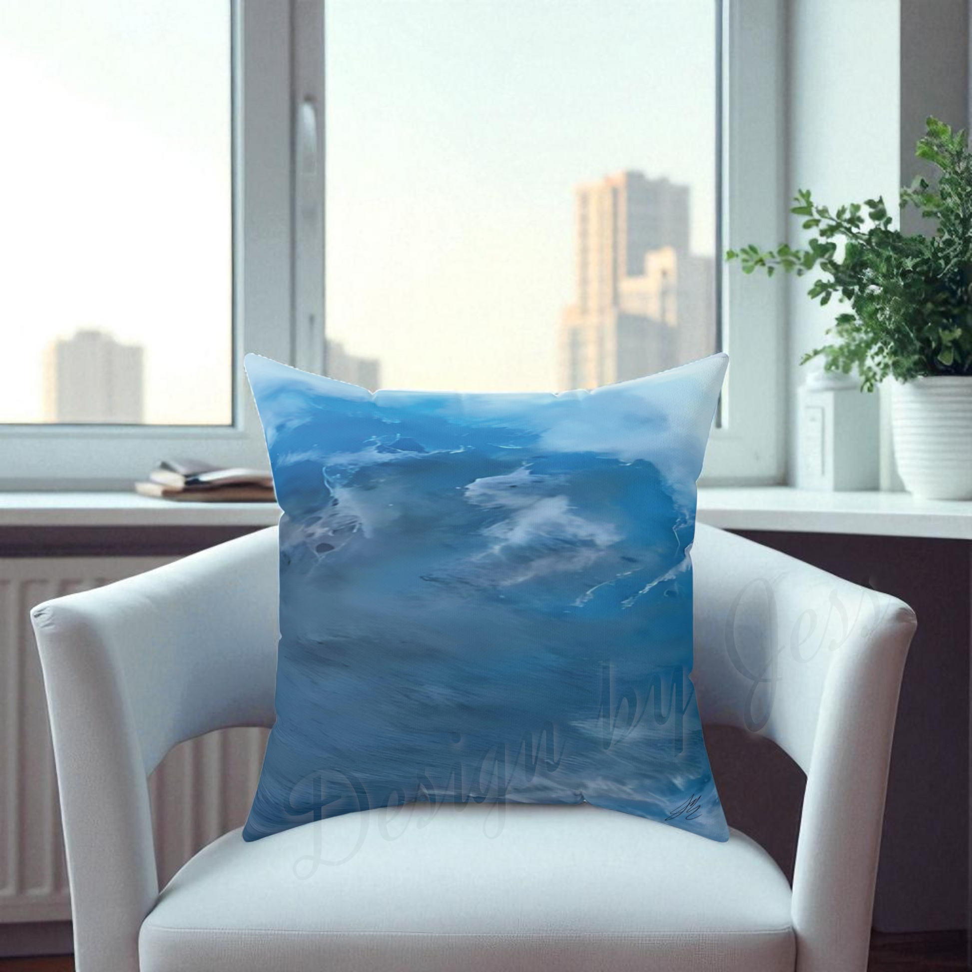 Blue pillow with water design on a white chair in a room with large windows.