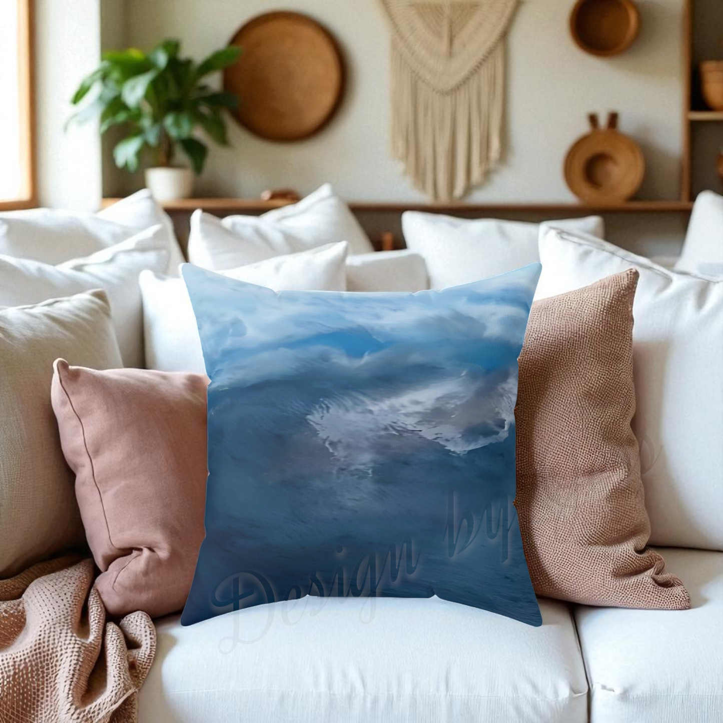 Decorative pillow with a blue cloud design on a white couch