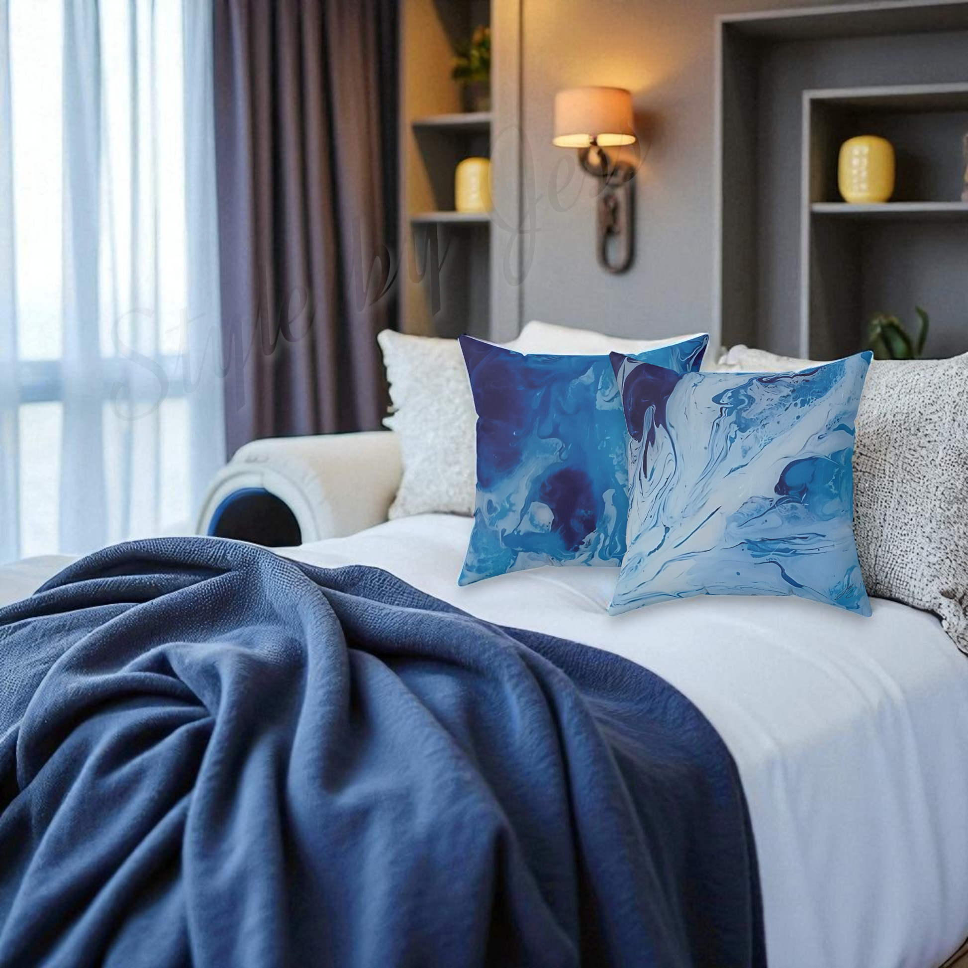 Blue abstract patterned pillows on a bed in a bedroom setting