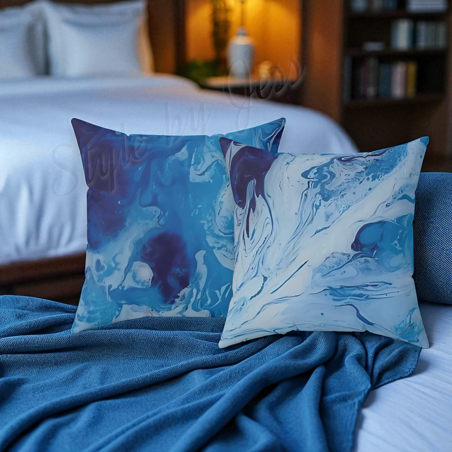 Blue and white marbled throw pillows on a bed with a blurred bedroom background.