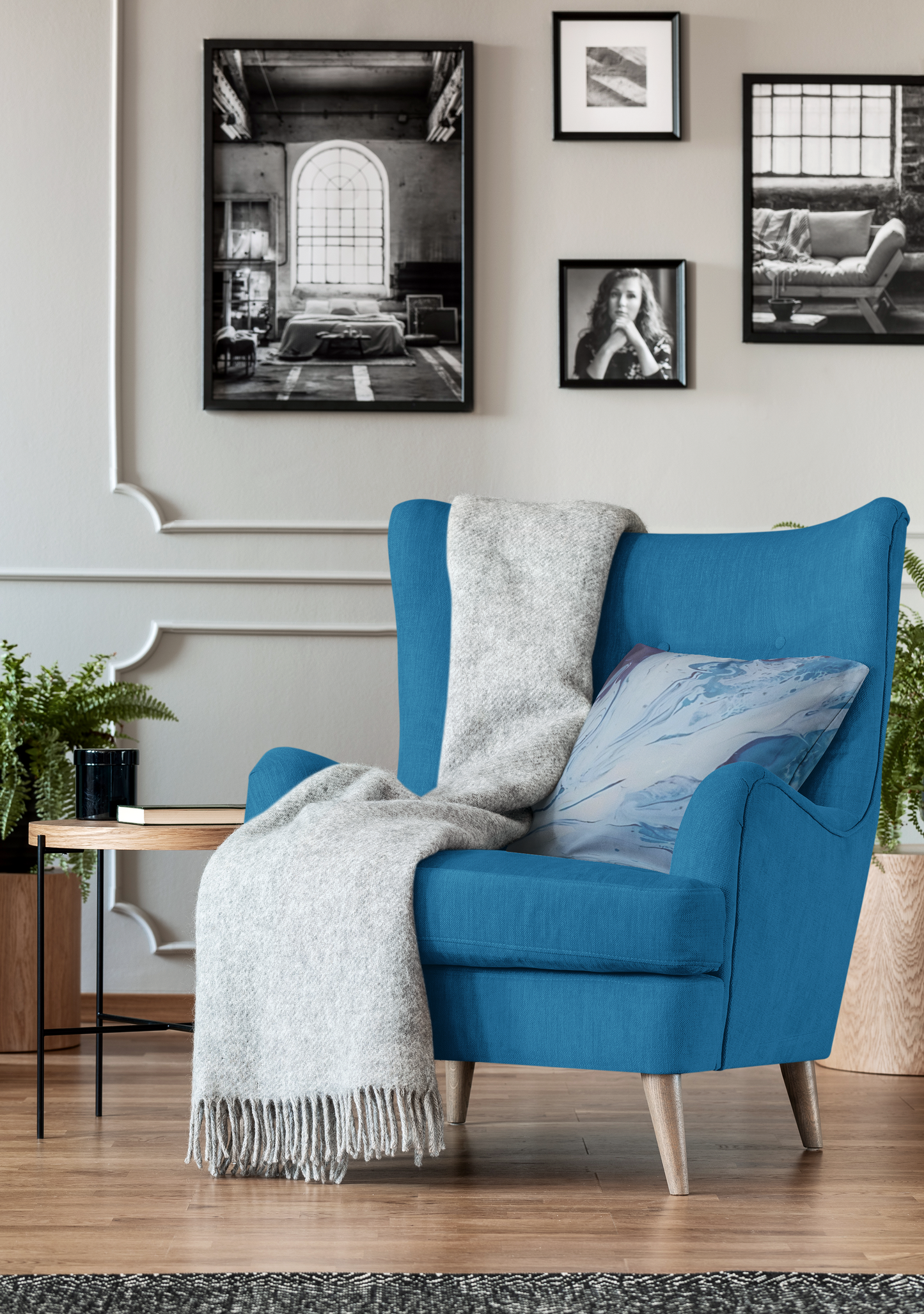 Blue armchair with a blanket and pillow in a living room setting