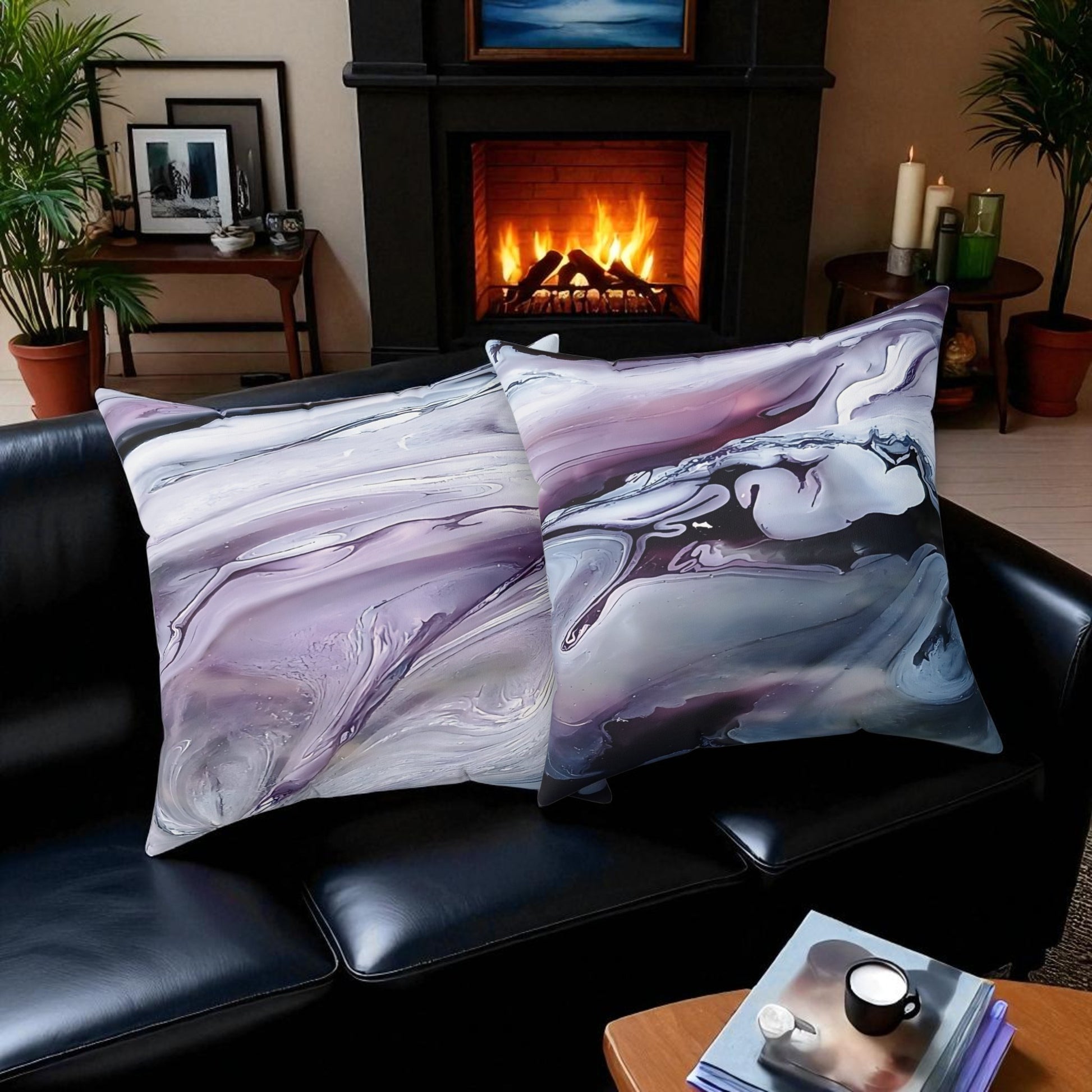 Marble-patterned pillows on a black leather sofa with a fireplace in the background