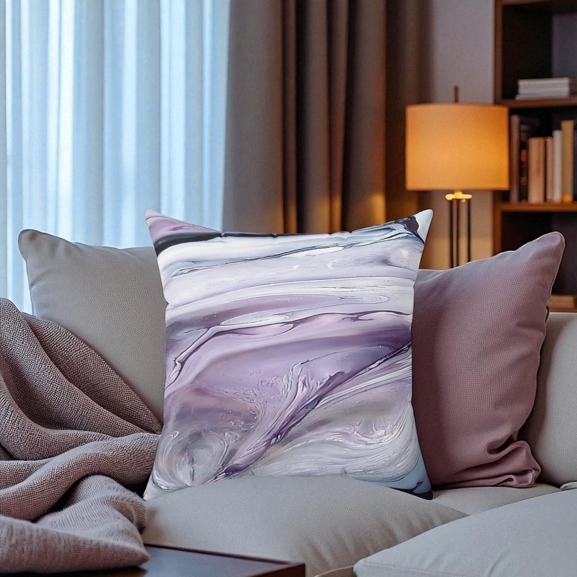 Decorative pillows on a sofa with a marbled pattern in a living room setting.
