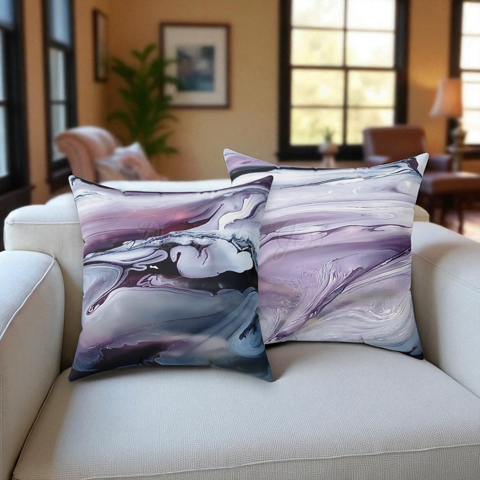 Marble-patterned pillows on a beige sofa in a living room setting.