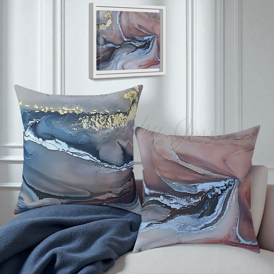 Two abstract-patterned pillows on a sofa with a painting in the background.