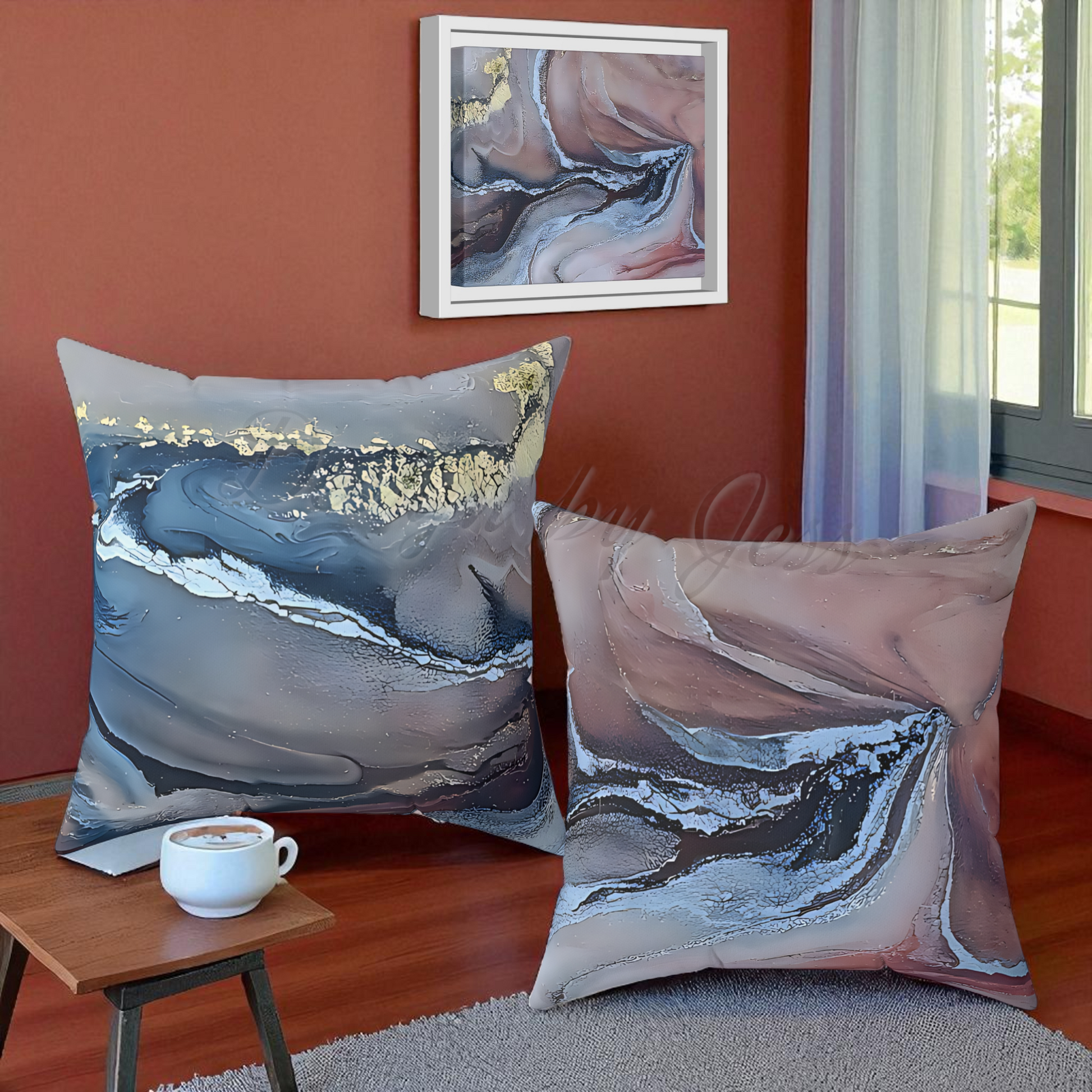 Two abstract-patterned pillows on a couch with a cup of coffee and a painting on the wall.