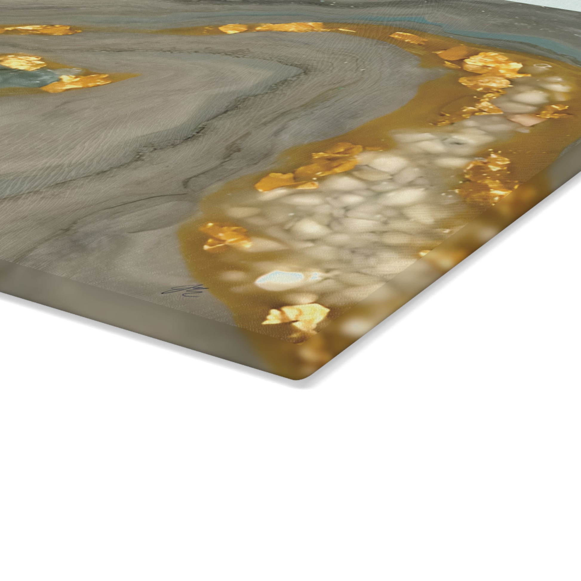 Close up view of tempered glass cutting board with gold and gray marble pattern