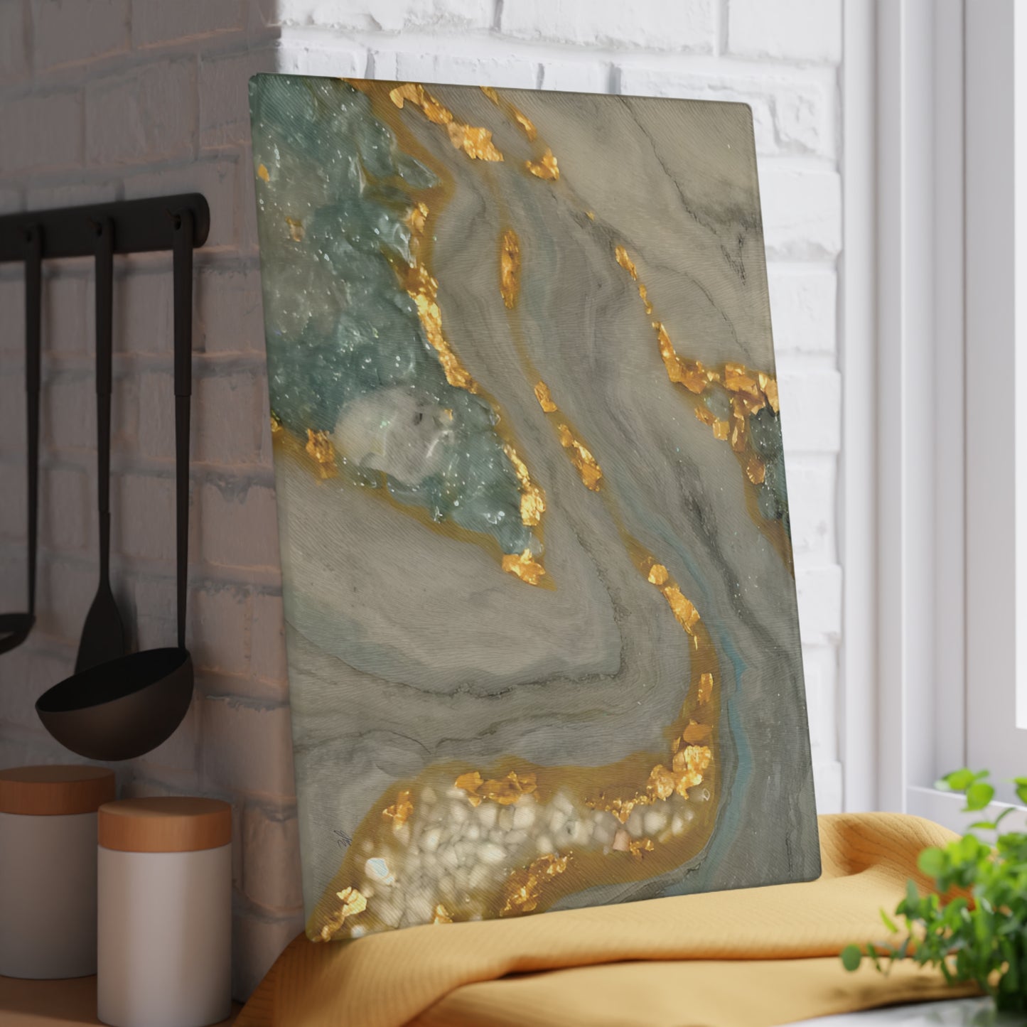 Decorative piece with gold and green marbled design on a kitchen counter. Style by Jess
