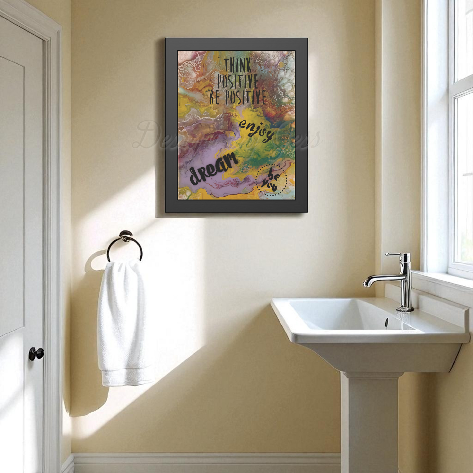 Bathroom with a framed motivational quote on the wall above a sink.