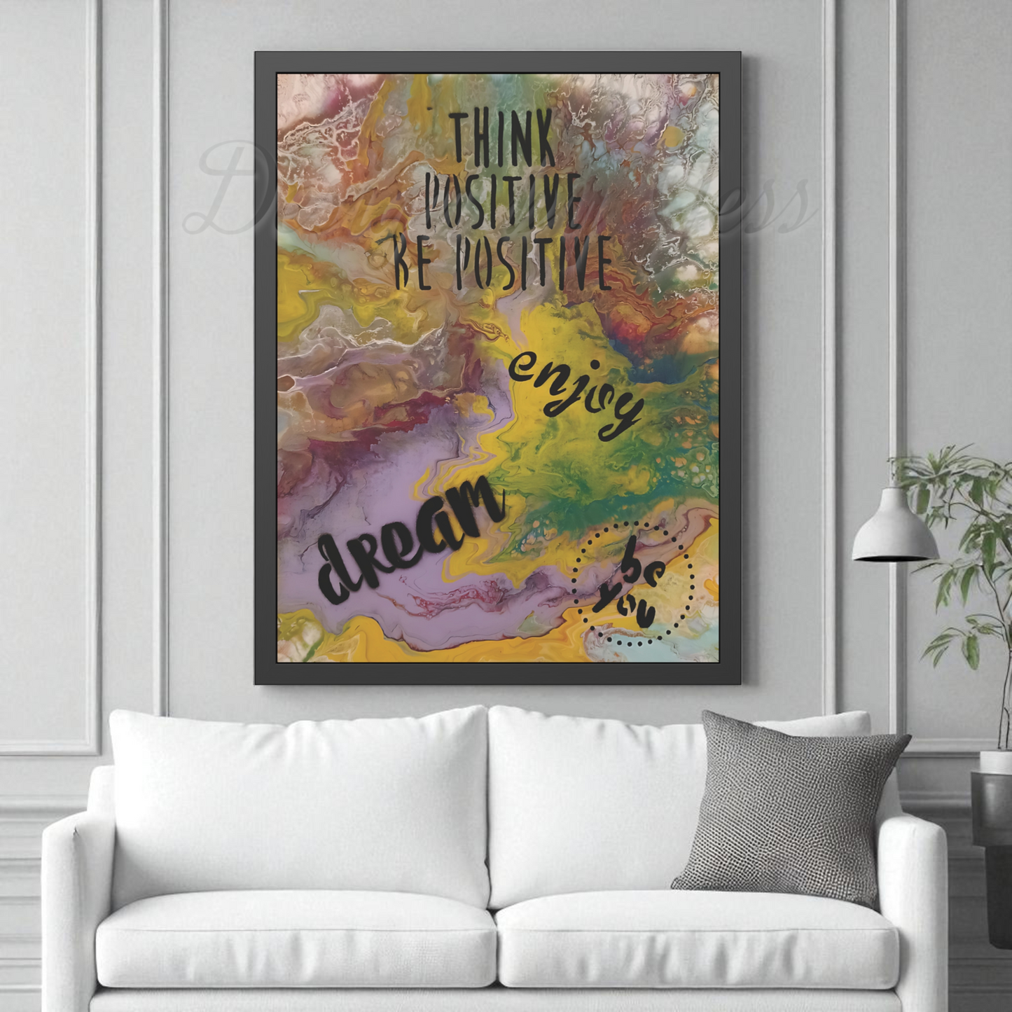 Colorful abstract wall art with motivational text above a white sofa.