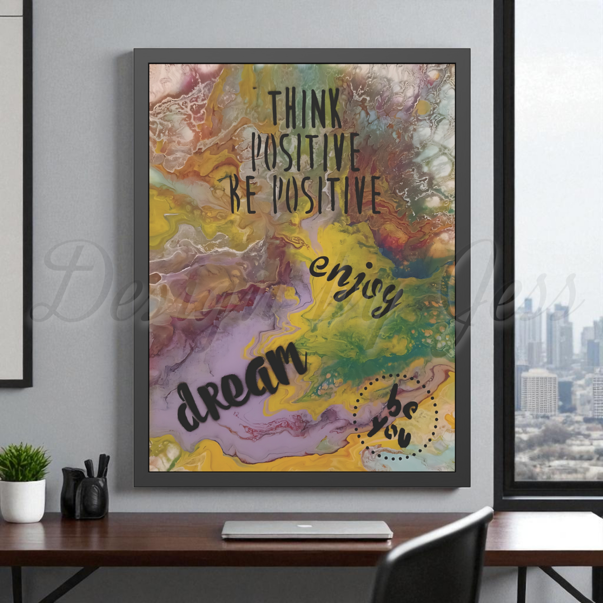 Framed abstract artwork with motivational text in a home office setting