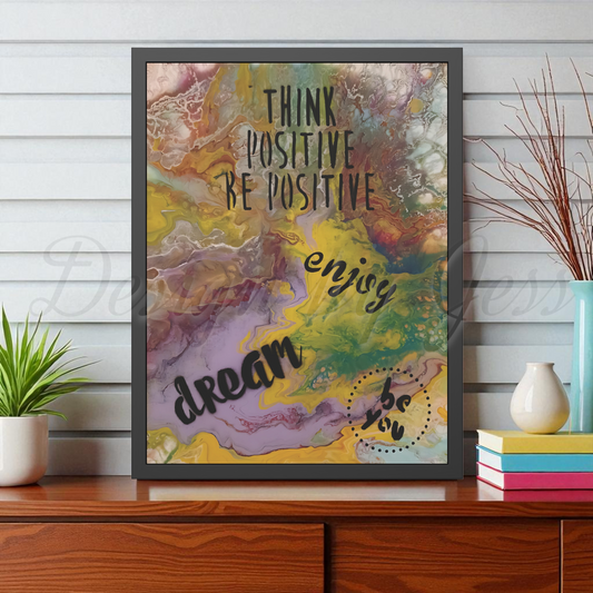 Framed motivational poster with abstract design and text on a wooden surface. Style by Jess