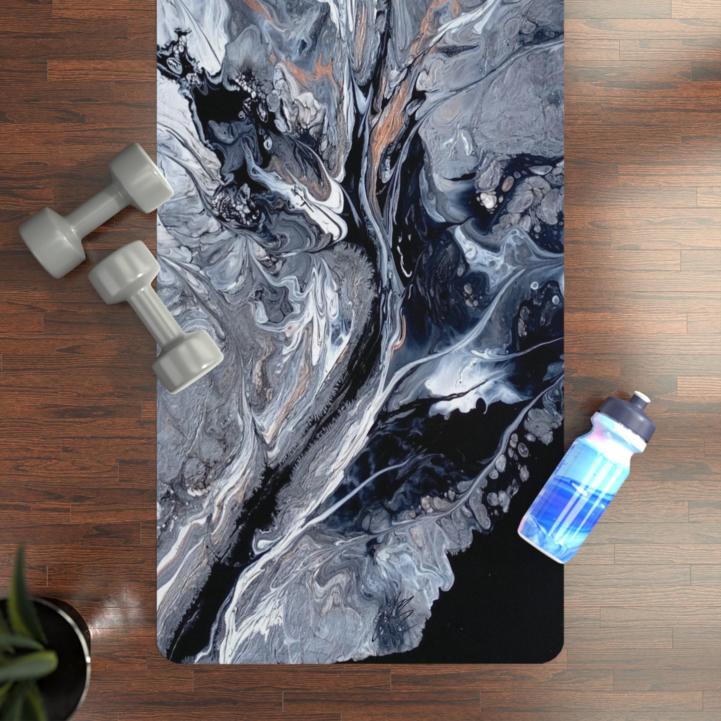 Marbled yoga mat with two dumbbells and a water bottle on a wooden floor.