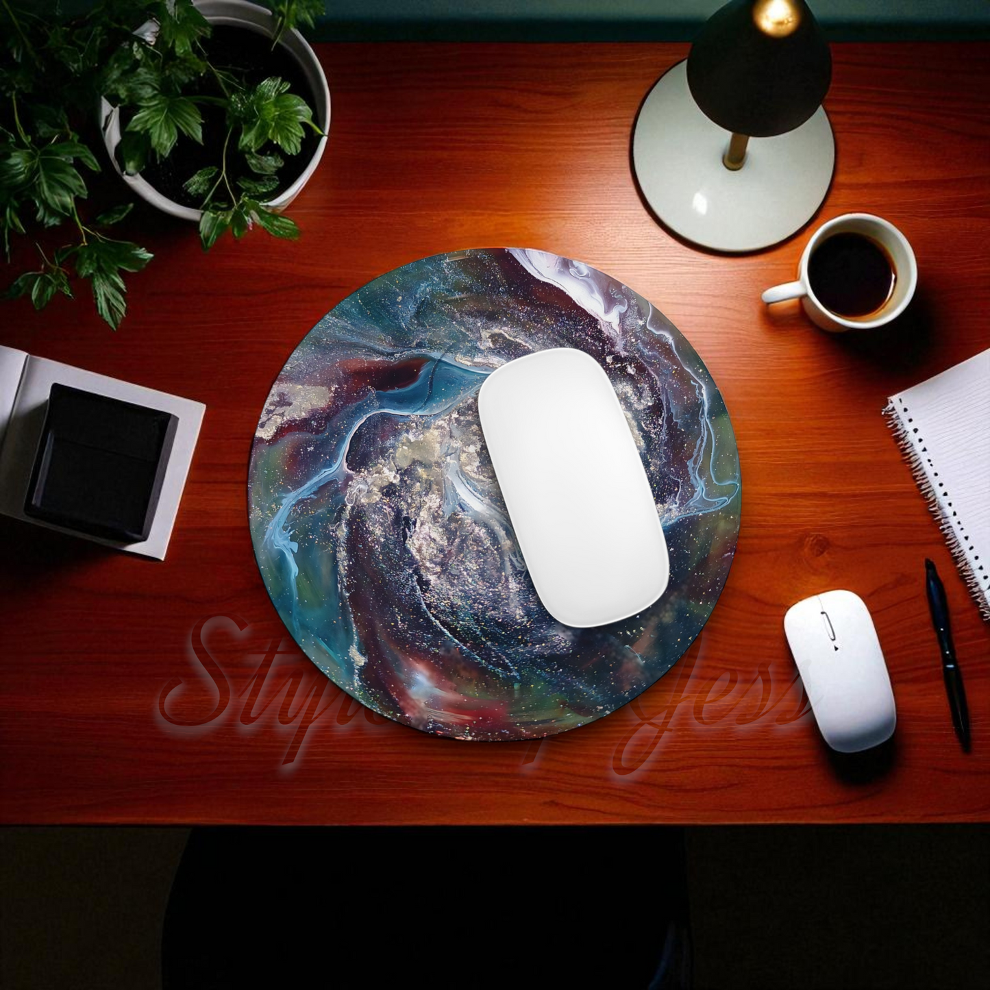 Mouse pad with a colorful design on a wooden desk with office items.
