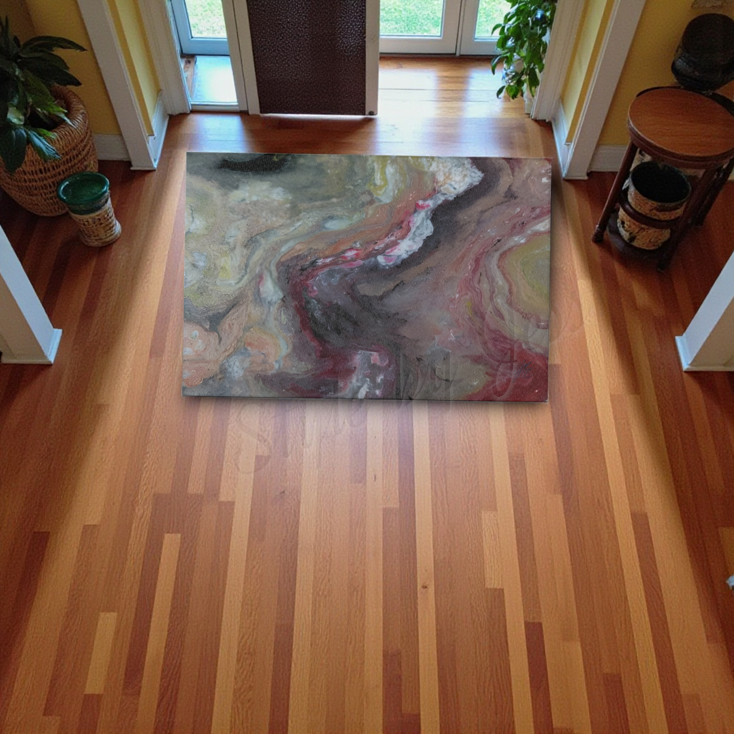 Marbled area rug on a wooden floor with plants and furniture around