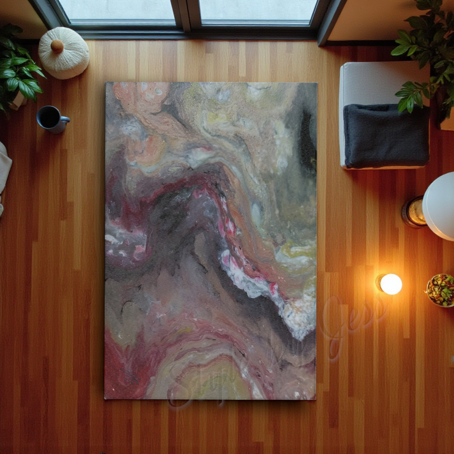 Abstract painting on accent rug on a wooden floor with a lamp and plant in the background
