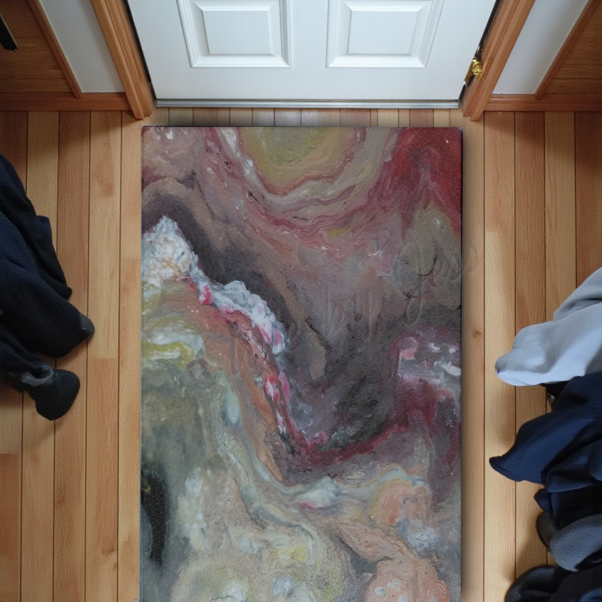 Colorful abstract rug on a wooden floor with a white door in the background