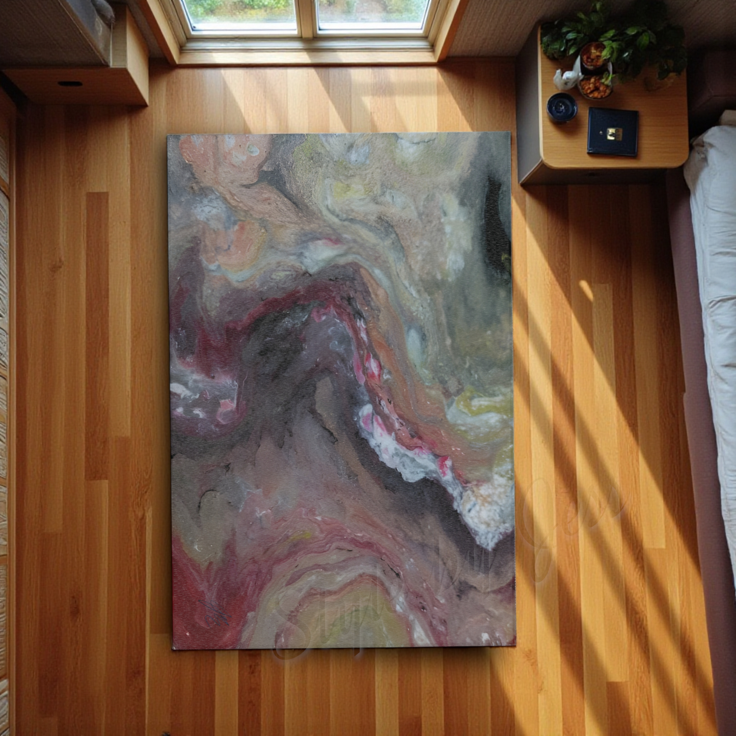 Abstract painting on a entry rug on a wooden floor with natural light