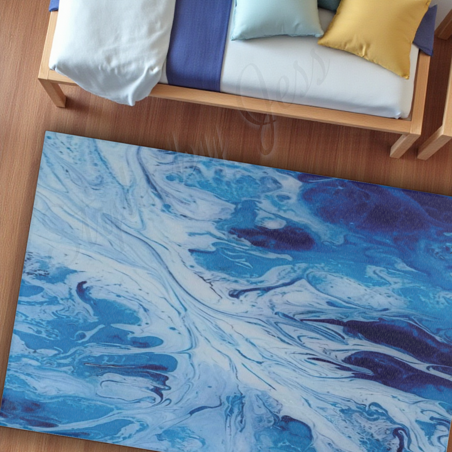 Blue and white marbled rug on a wooden floor with a bed in the background.