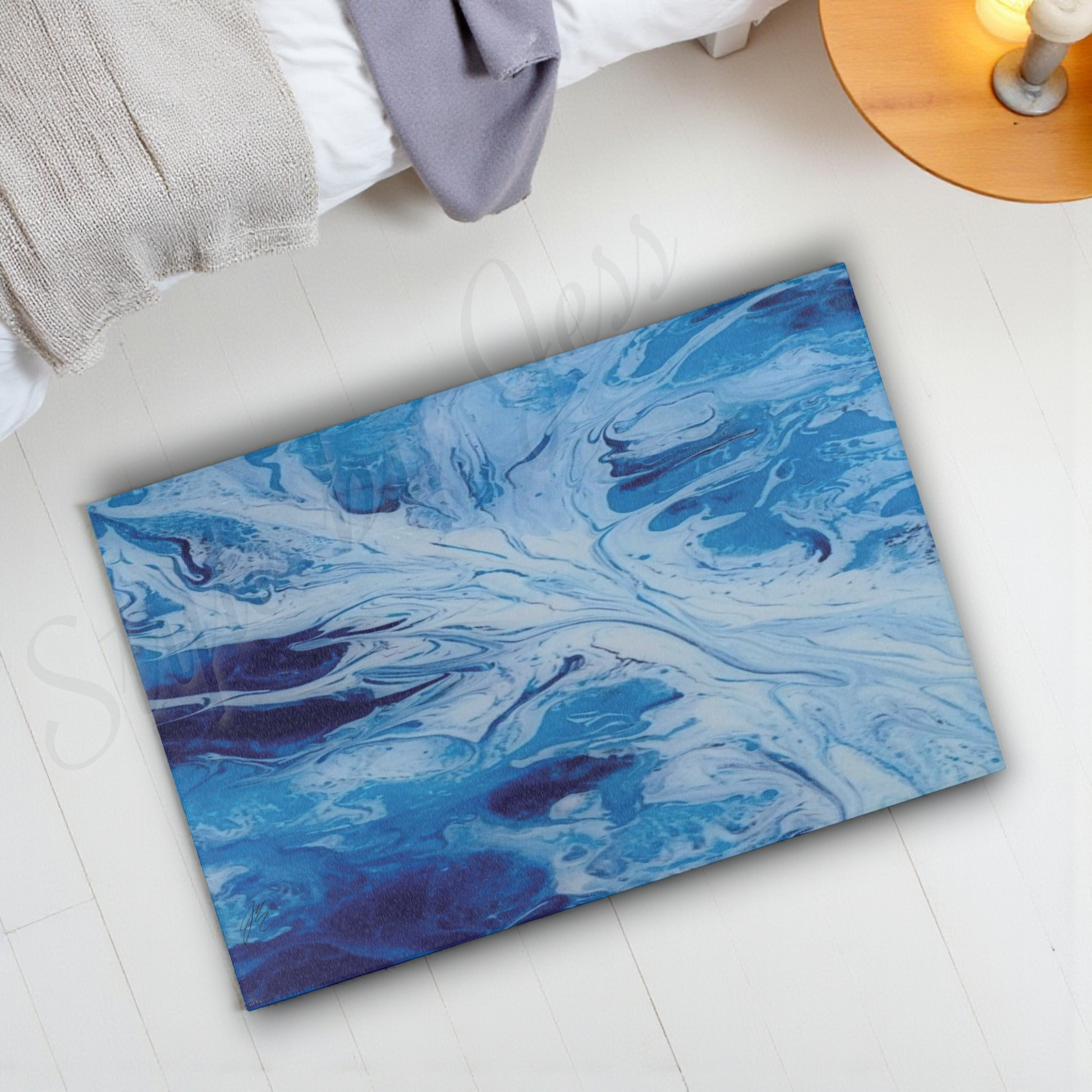 Blue marbled rug on a light wooden floor with a lamp in the corner.