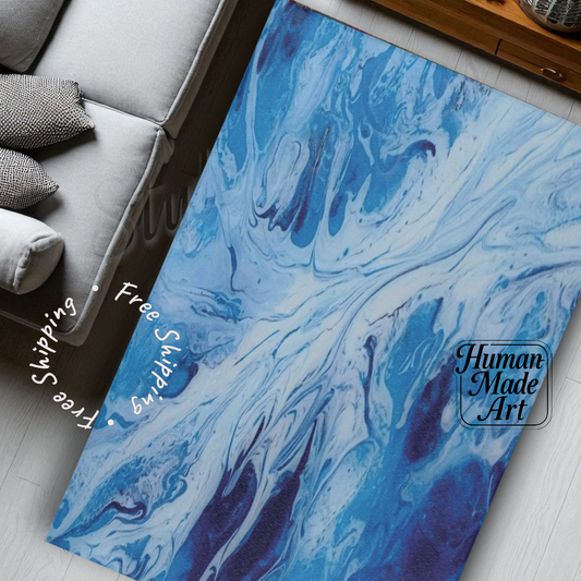 Blue and white rug on a floor with a sofa in the background, featuring 'Human Made Art' branding.