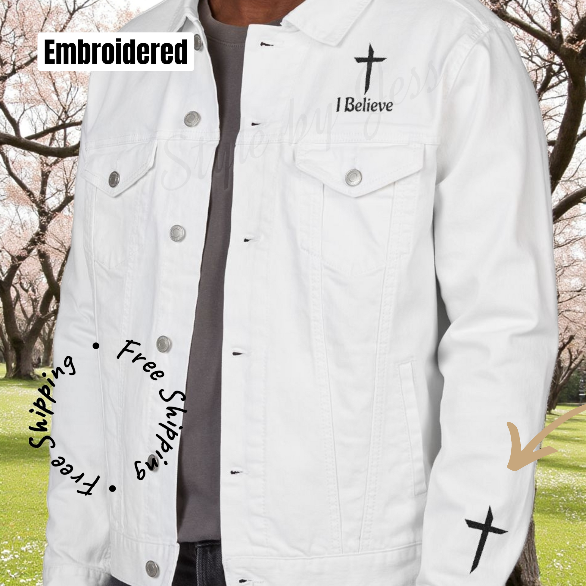 White denim jacket with embroidered text and design, outdoors.