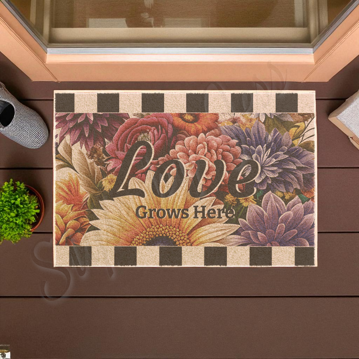Floral doormat with 'Love Grows Here' text on a wooden floor.
