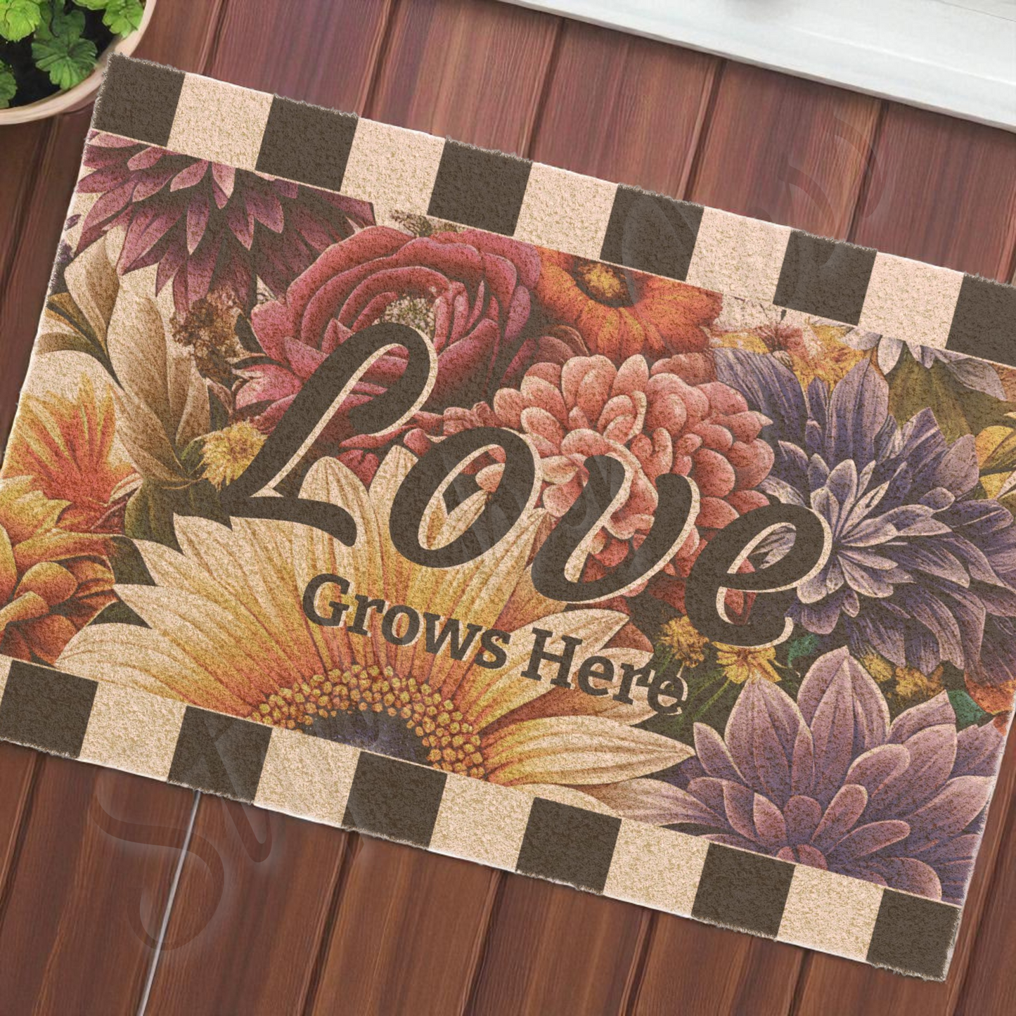 Floral winter mat with 'Love Grows Here' text on a wooden floor