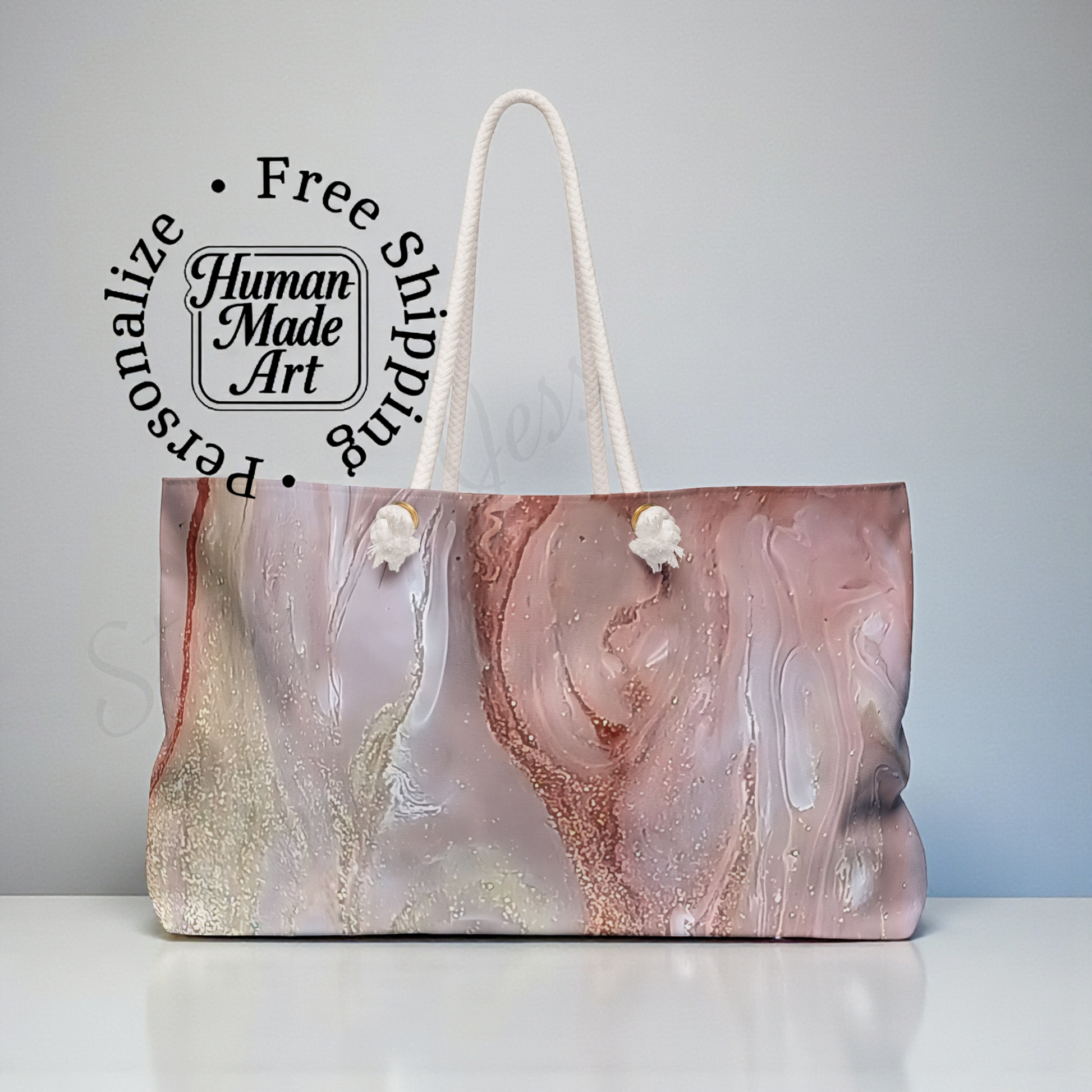 Marbled cloth tote bag featuring gold, blush and white colors with cotton shoulder straps on a gray background
