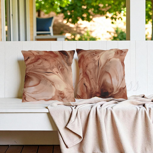 Two marbled patterned outdoor pillows on a white bench with a blurred outdoor background a Style by Jess at Gotta Have It Design