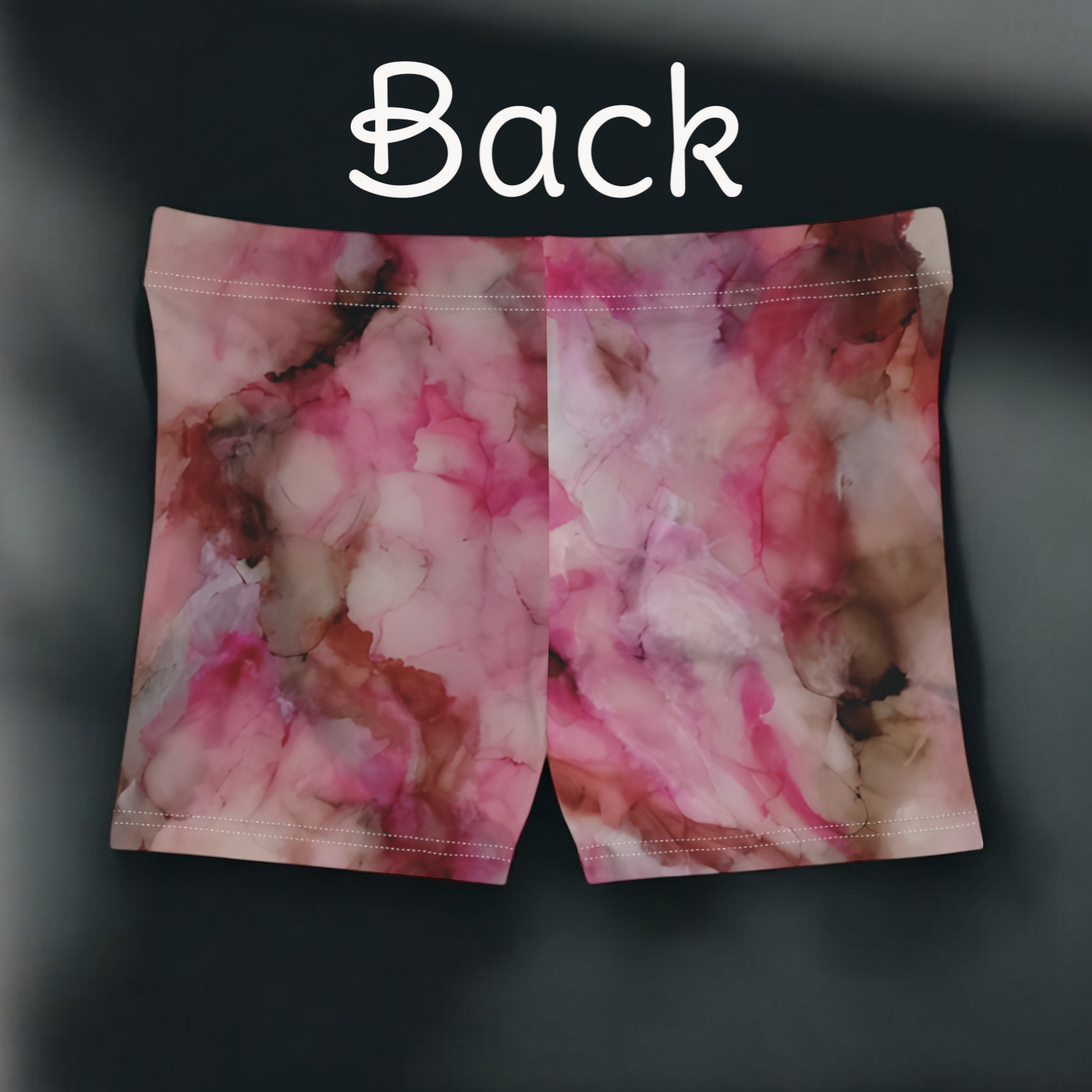Pink and white floral patterned shorts on a dark background with 'Back' text.