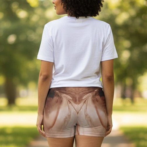 Person walking away on a path in a park with trees and greenery wearing booty shorts that accent the but a Style By Jess at Gotta Have It Design.