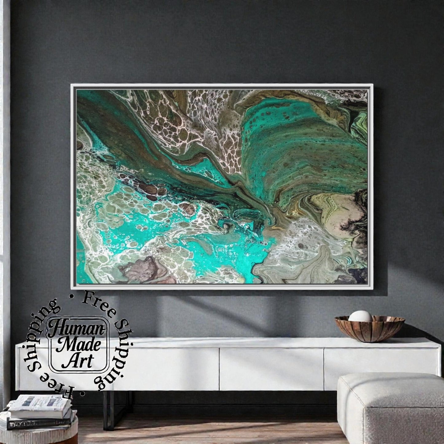 Abstract art piece with a white frame displayed on the wall in a modern entry way or office  setting with a dark wall.