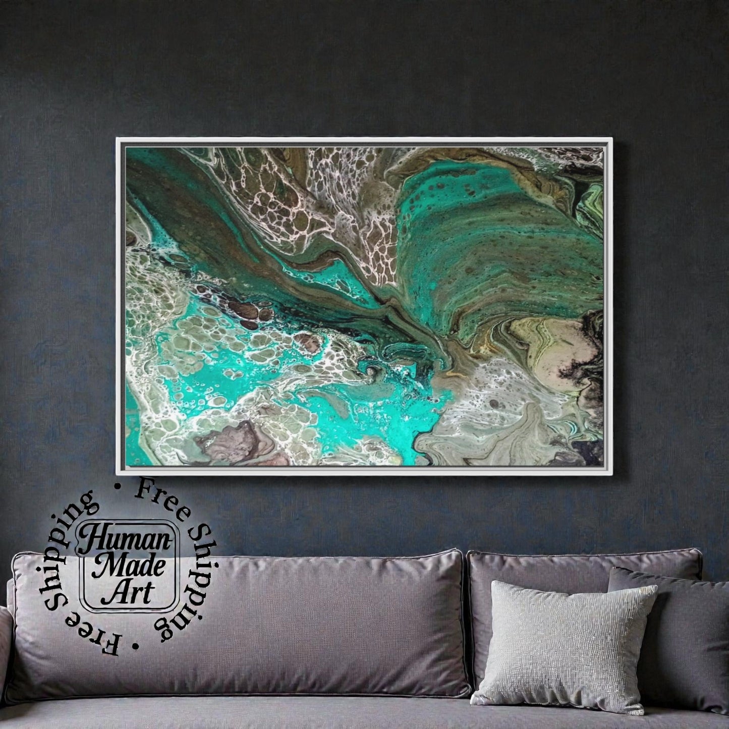 Abstract art piece on a dark wall above a gray sofa with decorative pillows.