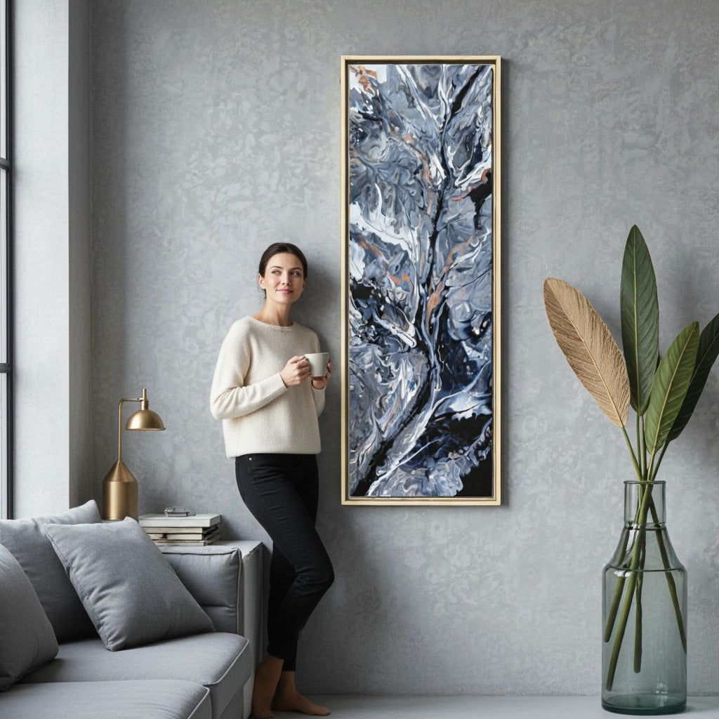 A woman in a living room standing next to a large vertical framed canvas art print of an original painting created by Jess with Style By Jess. 