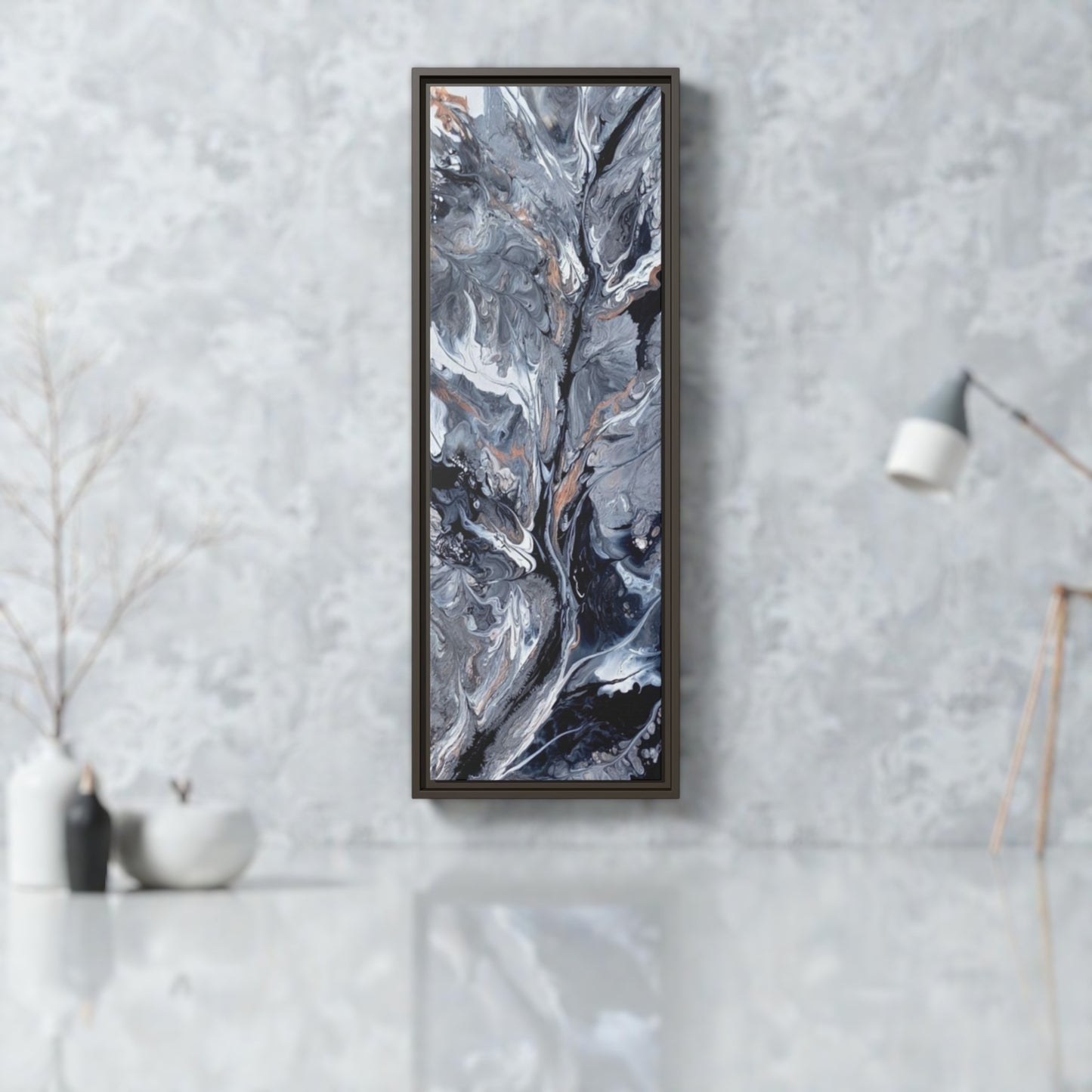 Framed abstract art piece on a gray wall in a contemporary office setting. 