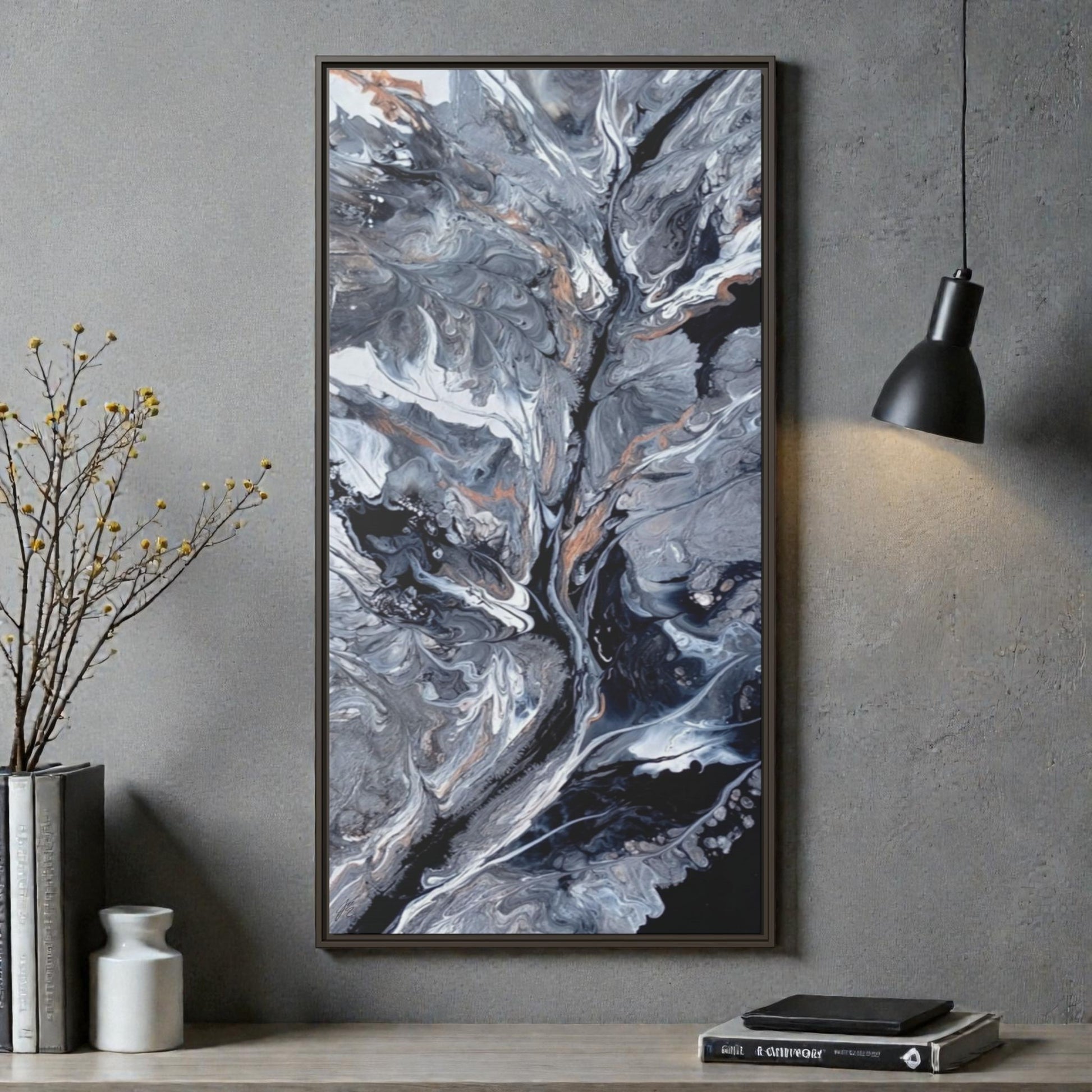 A large abstract art print on a wall above a desk in with office decor consisting in a light, books and home decor vases. 